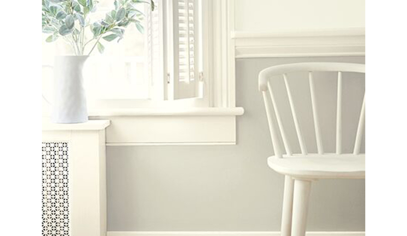 Hallway with white hues: wall, molding, window, shutters, chair