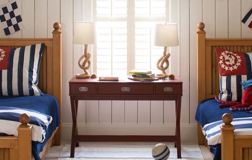 Nautical bedroom with white shiplap walls and two twin size beds. Nautical bedroom with white shiplap walls and two twin size beds.
