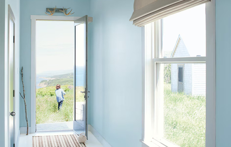 Hallway walls with light blue Breath of Fresh Air 806 color, white trim, and open door. Hallway walls with light blue Breath of Fresh Air 806 color, white trim, and open door.